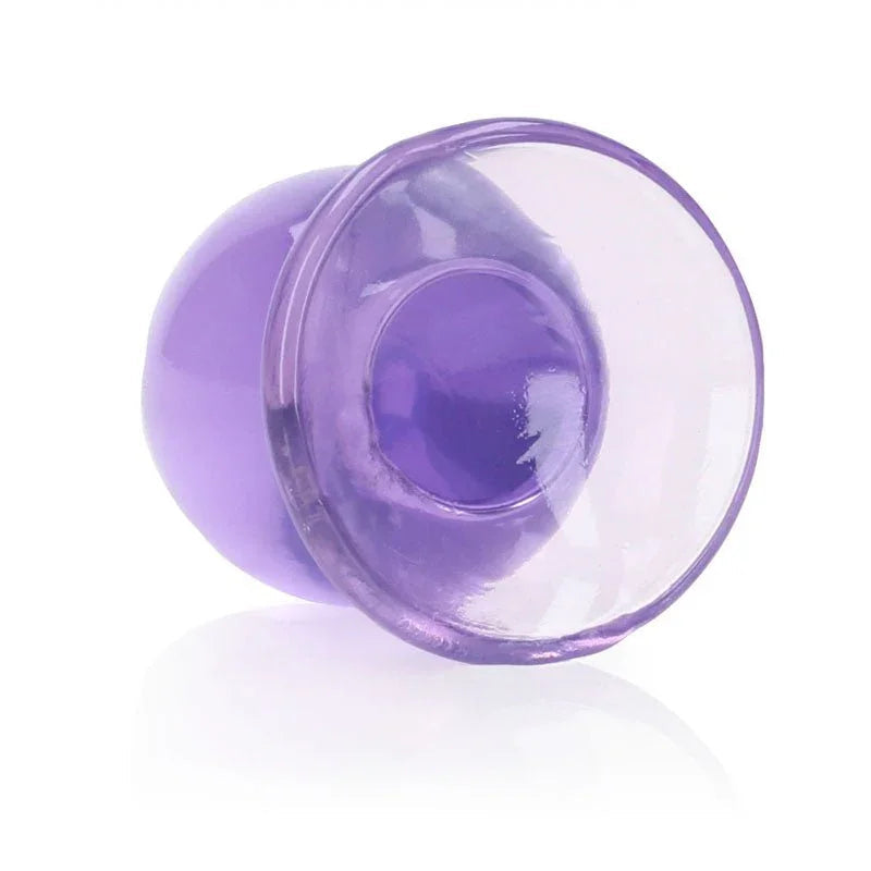 REALROCK 9 cm Anal Plug in Purple, tipped over so the flared base faces the camera
