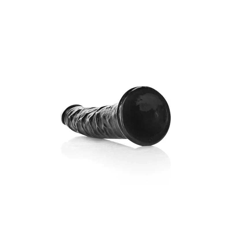 REALROCK 15.5 cm Realistic Slim Dildo in Black, lying down with the suction base facing the camera