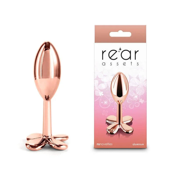 Rear Assets Clover metal butt plug in Rose Gold, clover-shaped base, beside its box