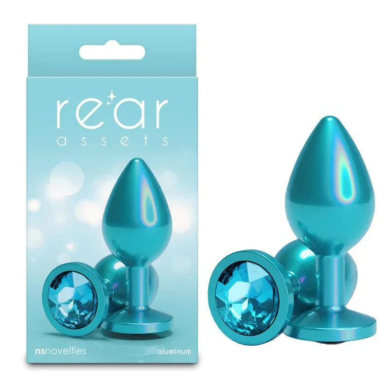 Rear Assets medium metal butt plug in Iridescent Teal, upright and base-on, with its box