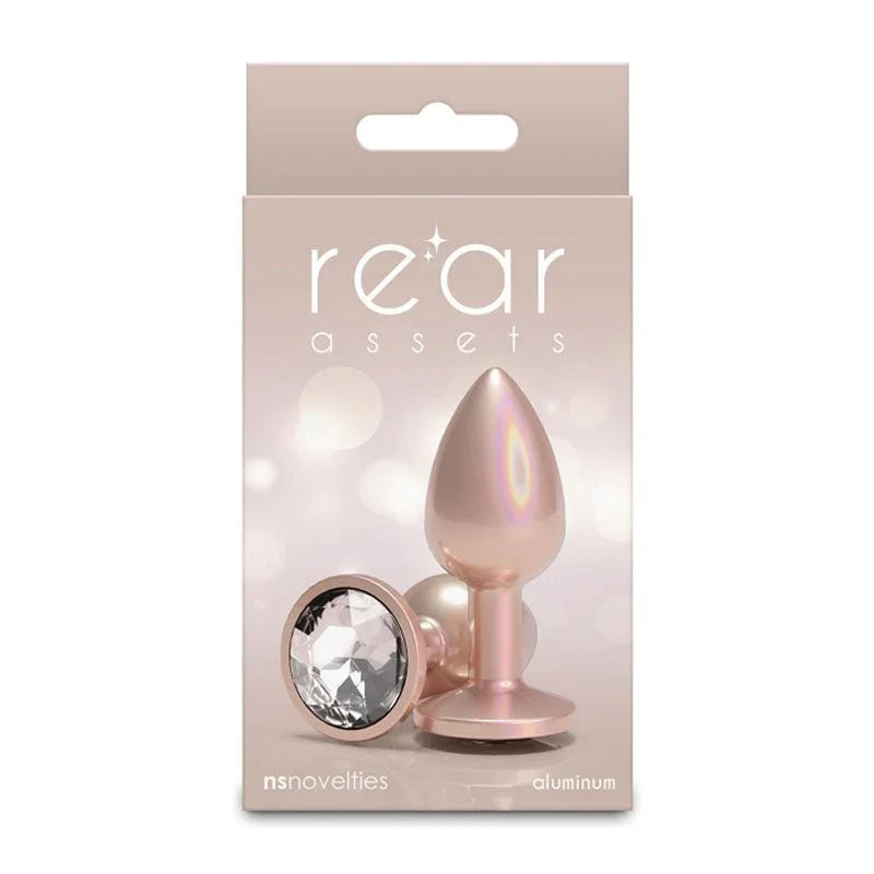 Rear Assets small box in champagne, picturing the plug and its clear round gem base