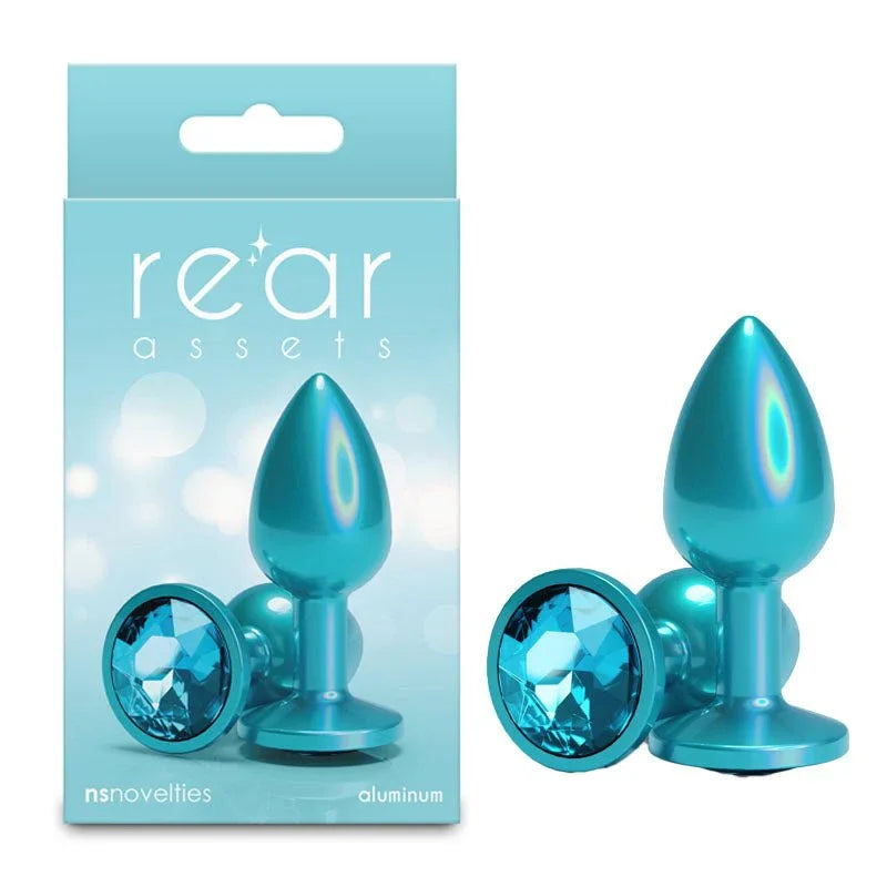 Rear Assets small metal butt plug in Iridescent Teal, upright and base-on, with its box