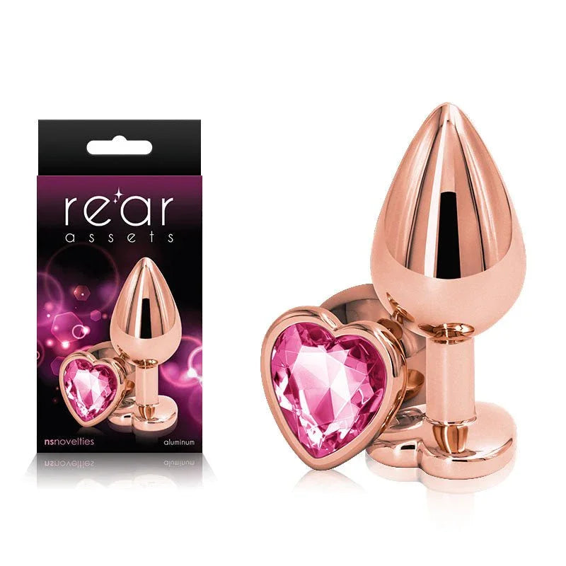 Rear Assets medium metal butt plug in Rose Gold with a pink heart gem base, and its box