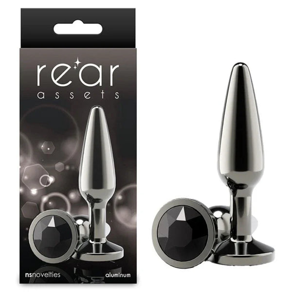 Rear Assets Tapered medium plug in Gunmetal with a black gem base, beside its box