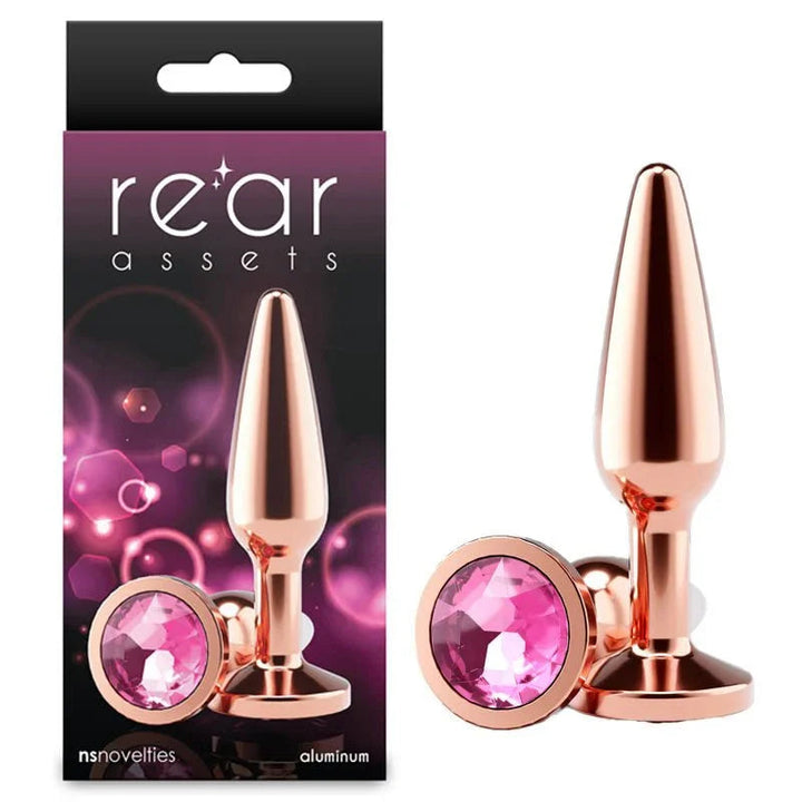 Rear Assets Tapered medium plug in Rose Gold with a pink gem base, beside its box