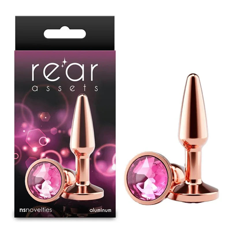 Rear Assets Tapered small plug in Rose Gold with a pink gem base, beside its box