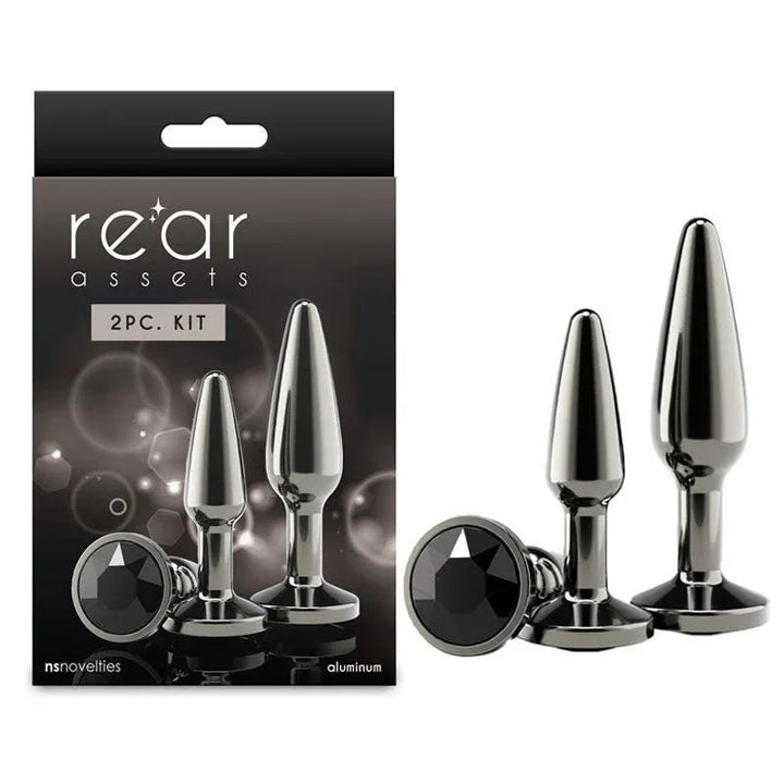 Rear Assets Tapered Trainer Kit in Gunmetal, two plugs and black gem beside the 2pc box
