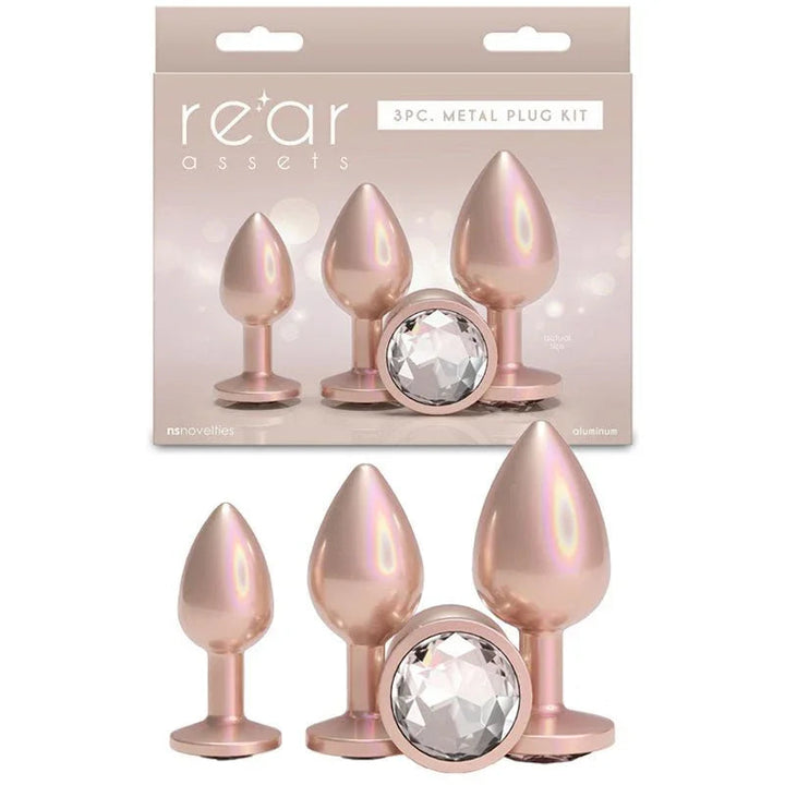 Rear Assets Trainer Kit in Iridescent Champagne, three plugs beside the 3pc kit box