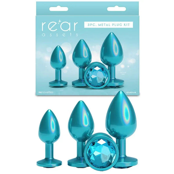 Rear Assets Trainer Kit in Iridescent Teal, three plugs beside the 3pc metal plug kit box