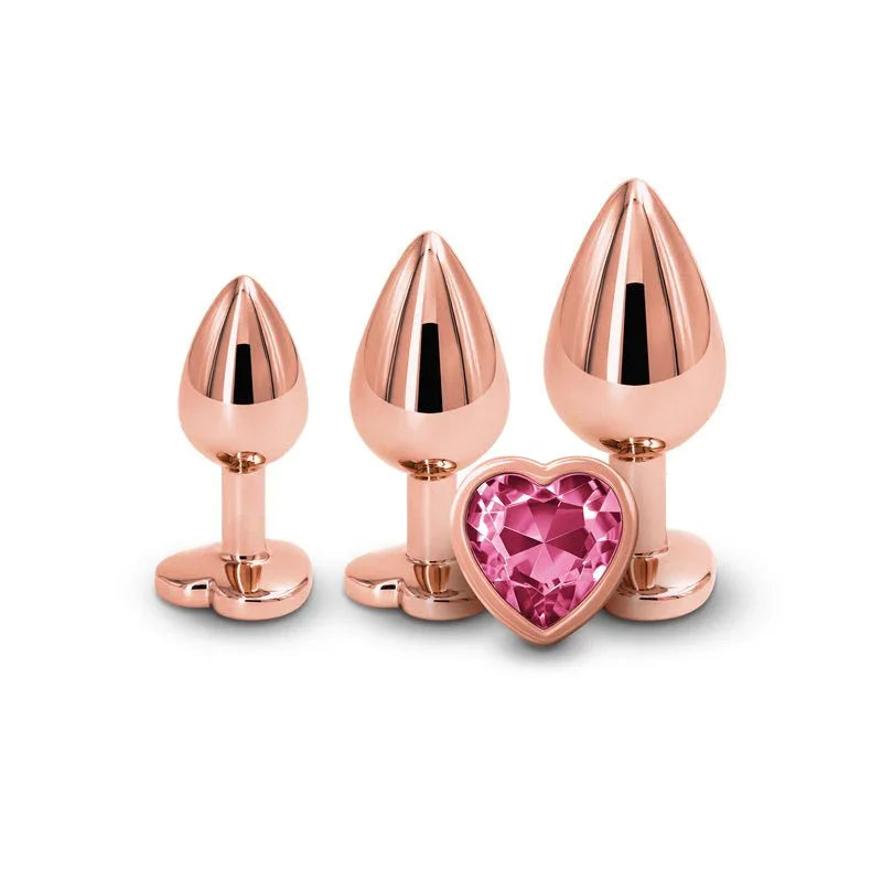 Rear Assets Trainer Kit in Rose Gold, three plugs upright with the pink heart gem base