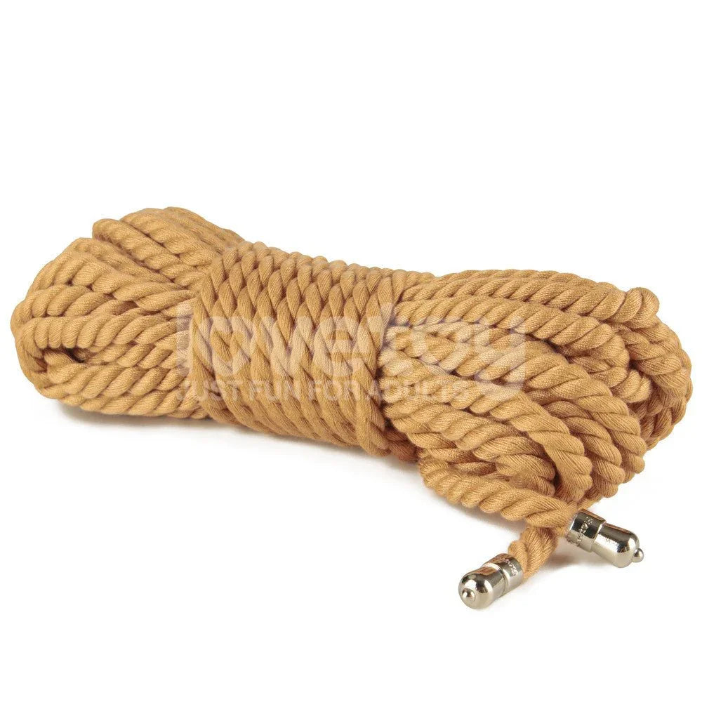 Hank of natural tan bondage rope on white, chrome tips at the near end