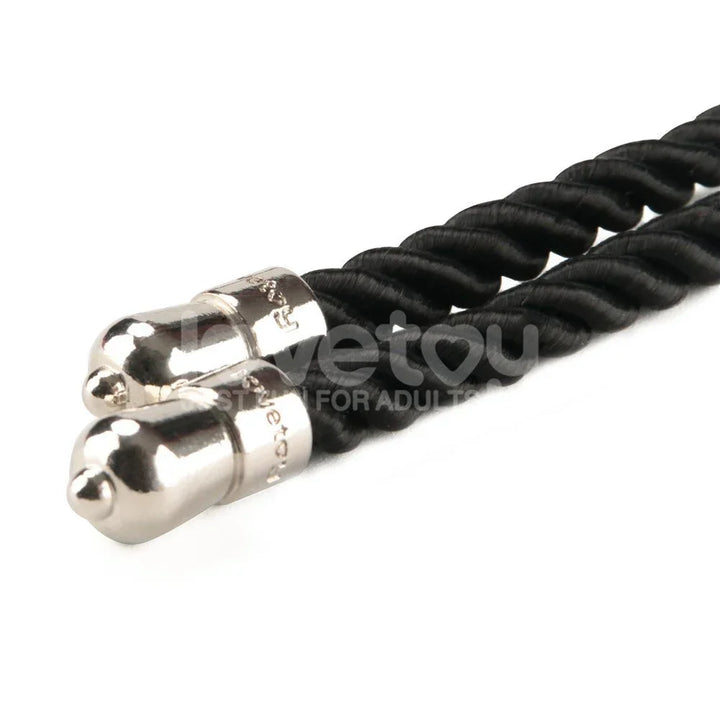 Close-up of the two chrome metal end caps on the black bondage rope