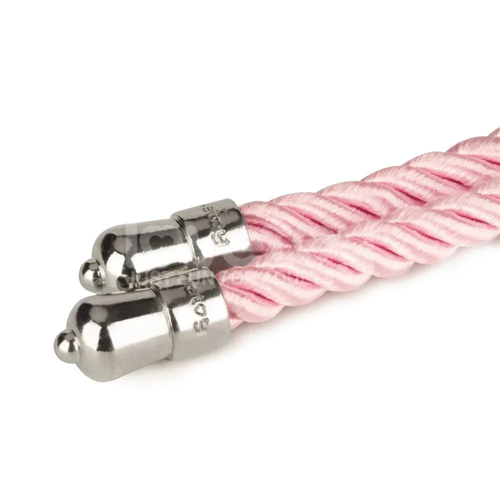 Detail of the chrome end caps crimped onto the pink bondage rope