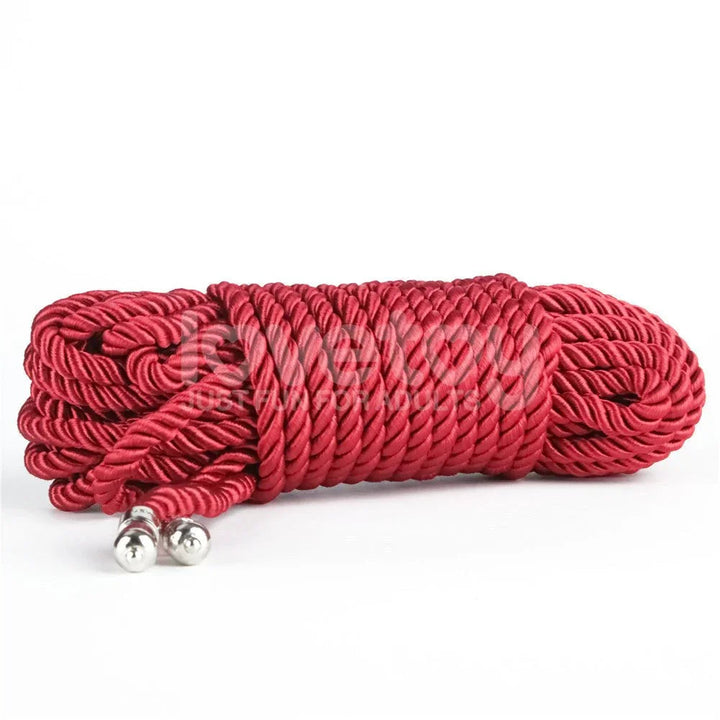 Hank of red silky bondage rope on white with both chrome end caps showing