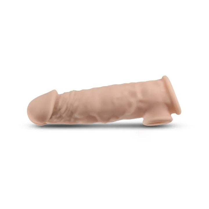 Renegade Annex Thick penis extender sleeve in Flesh, side view alone on white