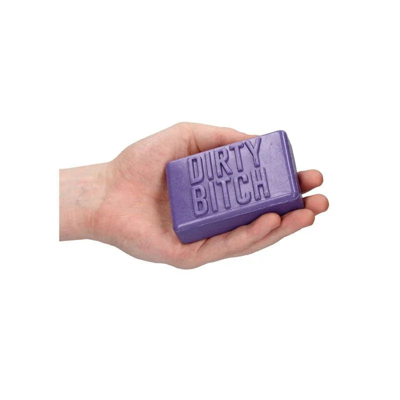 S-LINE Dirty Bitch Novelty Soap Bar in Purple, the bar held in an open palm for scale