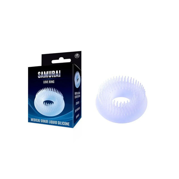 Samurai soft bristled cock ring in Clear, spiked silicone ring beside its navy box