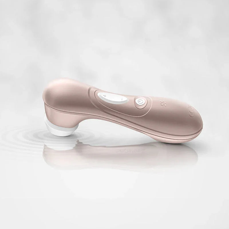 Satisfyer Pro 2 in rose gold resting on a wet white surface
