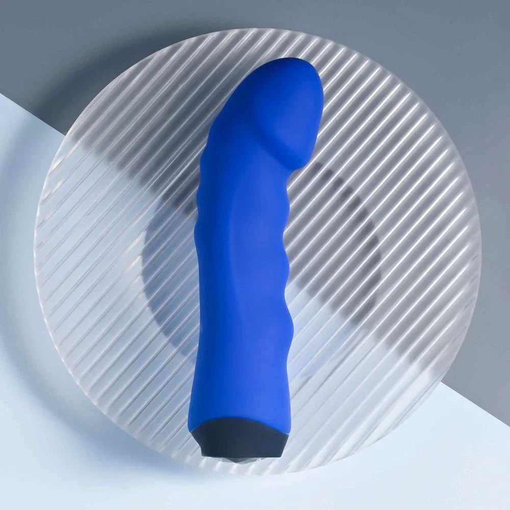 Blue Banger lying on a ribbed glass disc with the sculpted tip pointing up