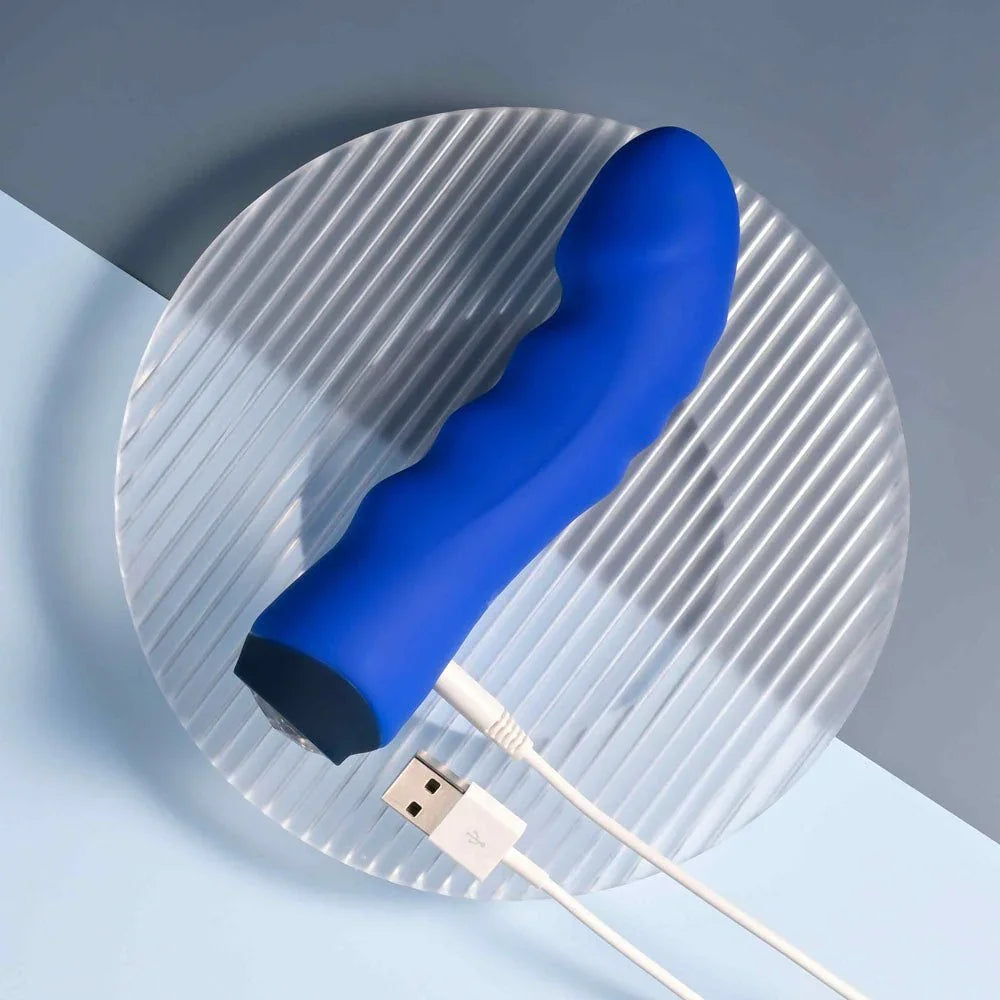 Blue Banger with its USB charging cable connected at the base