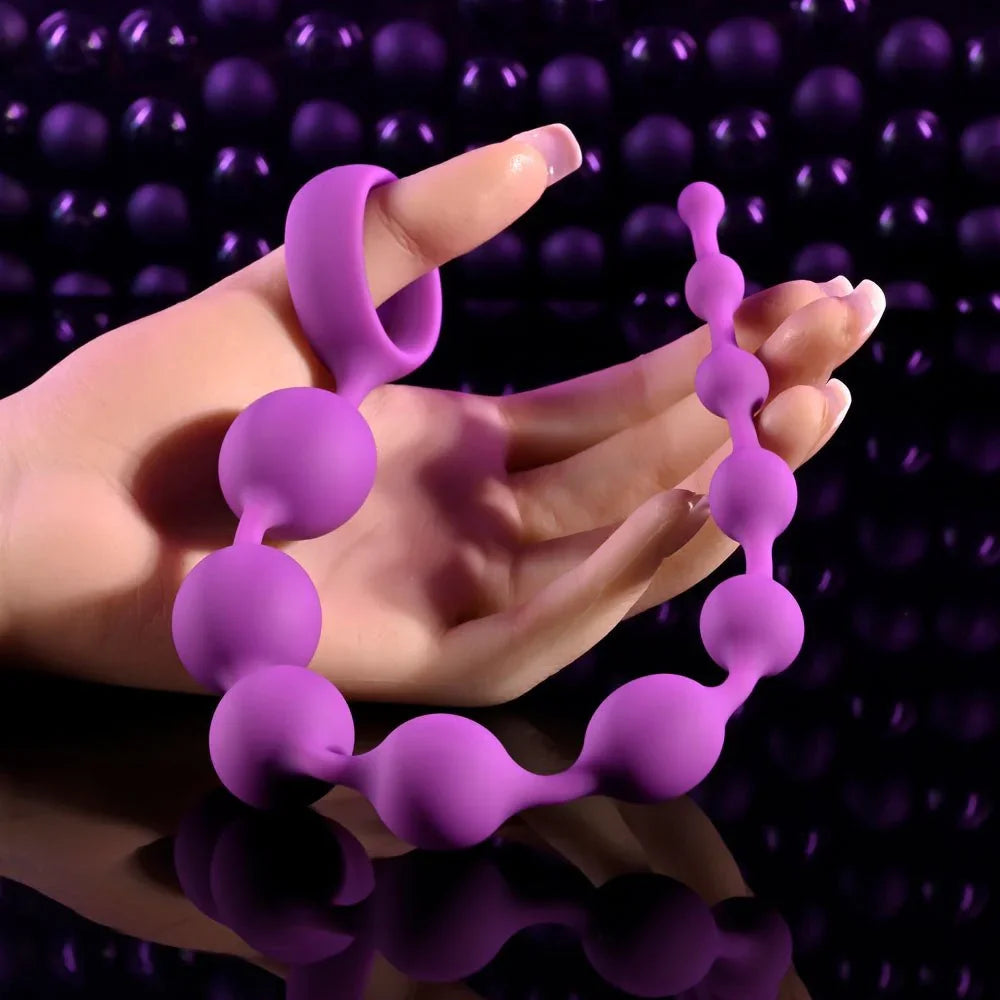 Beaded Adventure purple beads laid across a hand to show the bead sizes