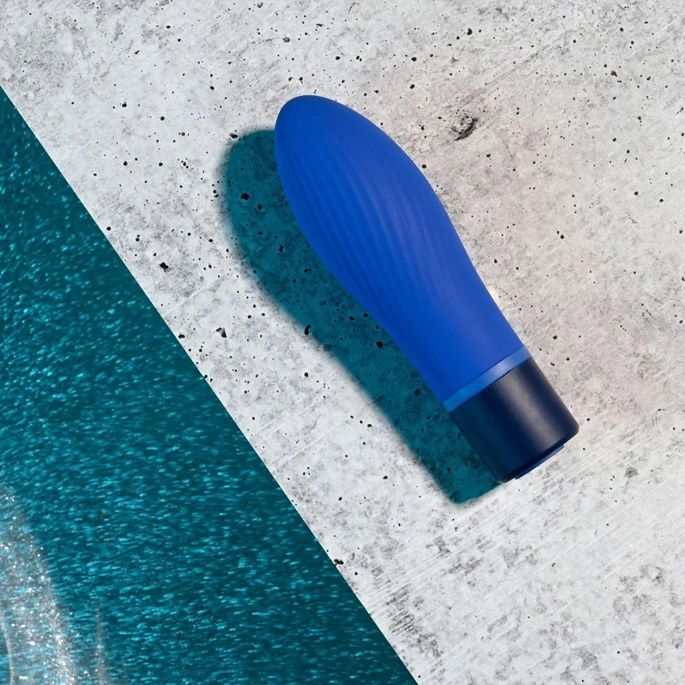 Cobalt Cutie lying on a grey concrete surface, ridged blue body