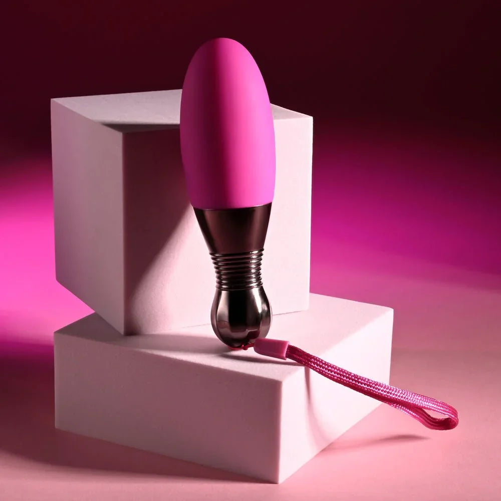 Companion egg standing upright on stacked pink plinths