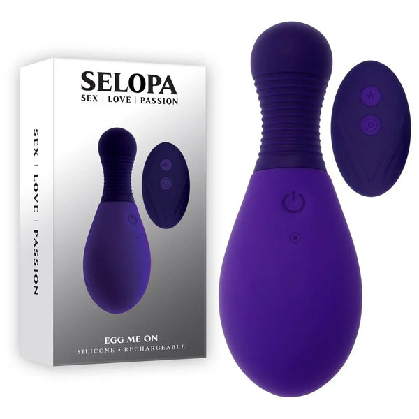 Selopa Egg Me On retail box beside the purple egg and its oval remote