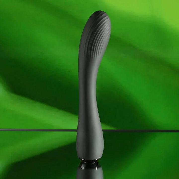 Midnight Magic standing upright against a green leaf, ribbed curved tip