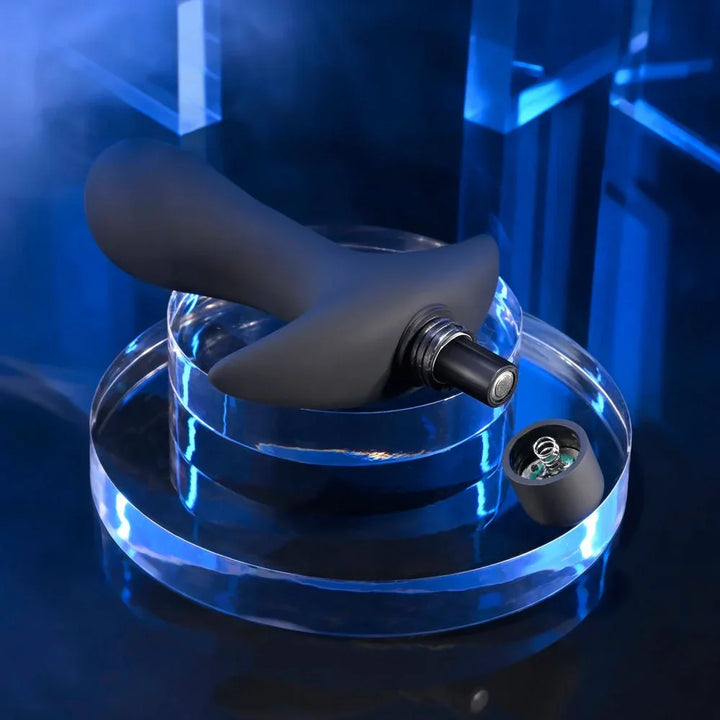 P-Spot Trainer with the bullet pulled out and a battery cell beside it