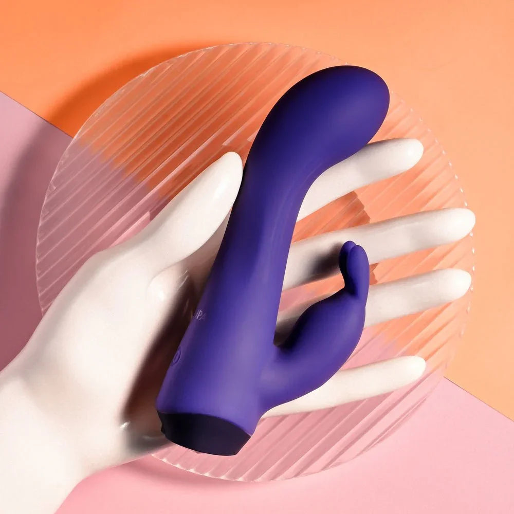 Plum Job resting on a white mannequin hand