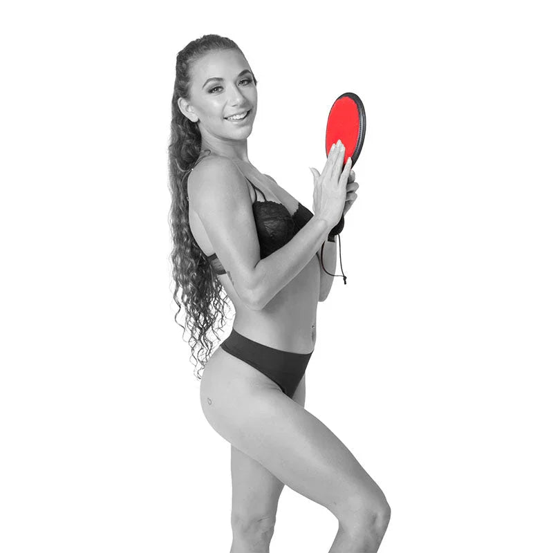 Model tapping the red Amor Paddle against her palm