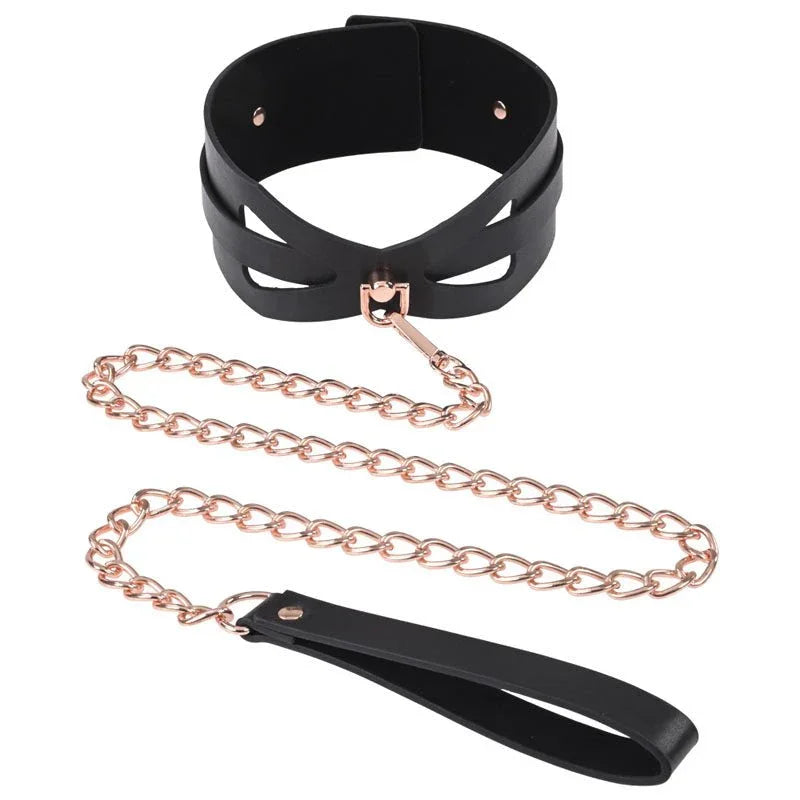 Black Brat collar with the rose gold chain leash coiled beneath it