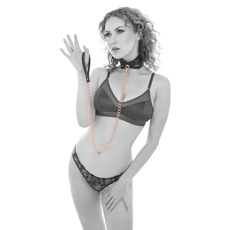 Model wearing the Brat collar and holding the rose gold leash handle