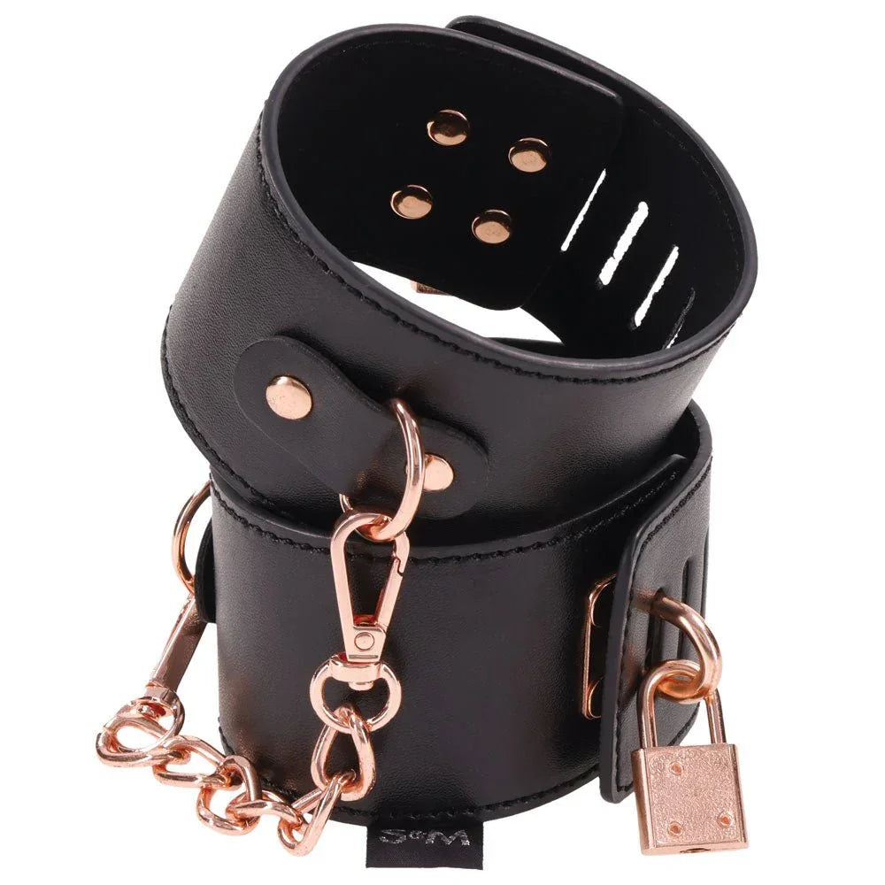 Brat locking cuffs stacked, showing the rivets, padlock and rose gold clip