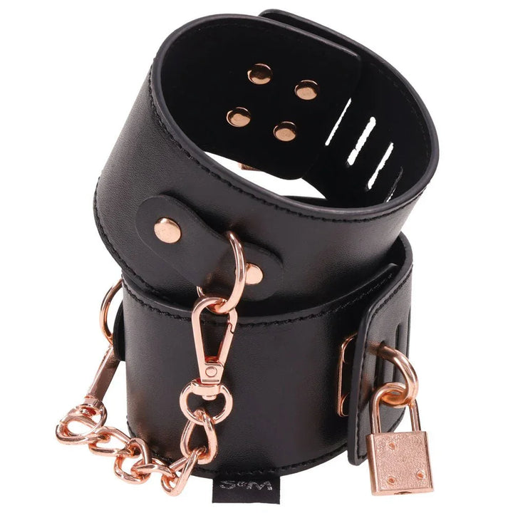 Brat locking cuffs stacked, showing the rivets, padlock and rose gold clip