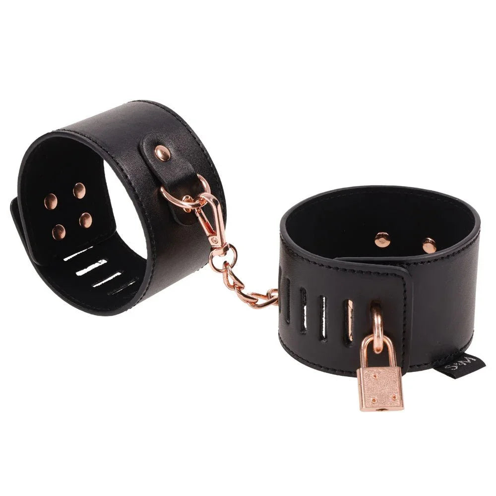 Black Brat locking cuffs with a rose gold padlock and swivel clip
