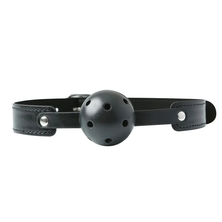 Breathable ball gag laid flat, vented black ball on a black leather strap