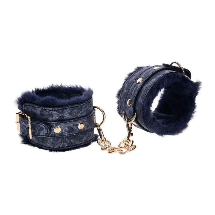 Cougar fur handcuffs angled, navy fur lining and gold chain between them