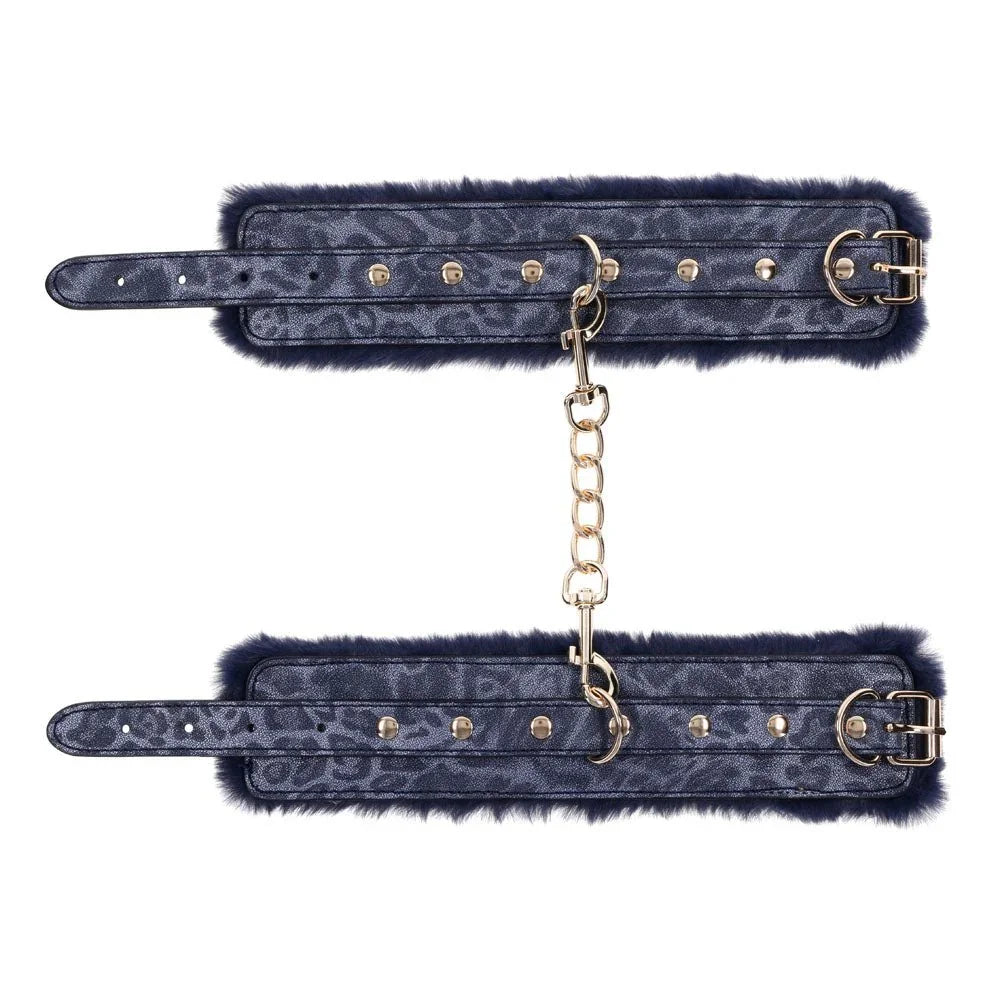 Both Cougar cuffs laid flat with the gold chain running between them