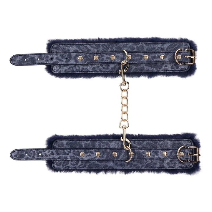 Both Cougar cuffs laid flat with the gold chain running between them