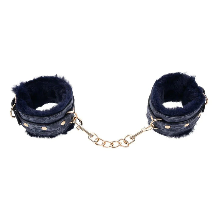 Cougar fur handcuffs held apart with the gold chain stretched between