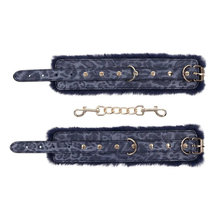Cougar cuffs laid open with the gold chain and swivel clips below