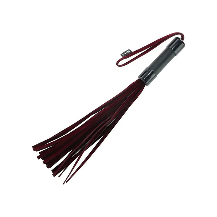 Enchanted Flogger laid horizontally with the burgundy falls fanned out