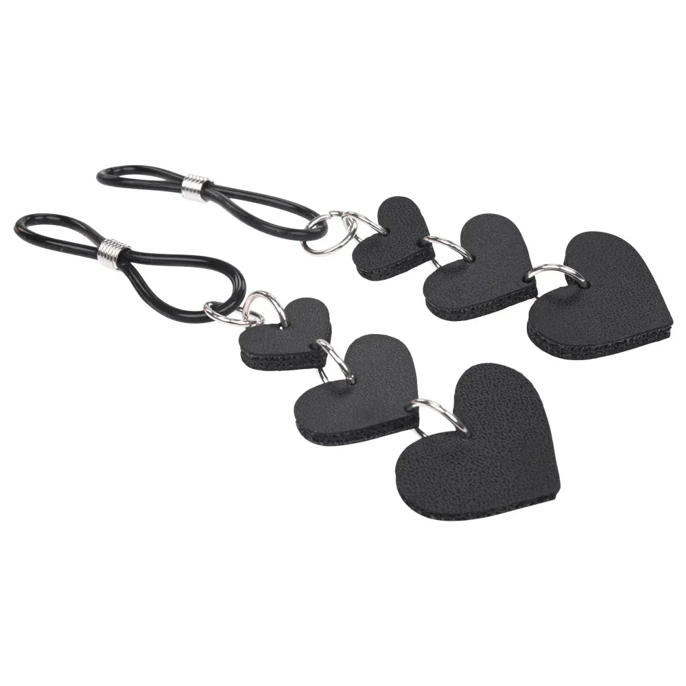 Heart nipple ties laid flat with the hearts fanned out across the frame