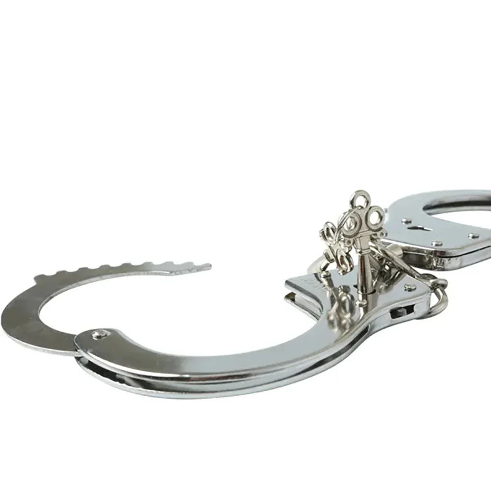 Close-up of a handcuff's ratchet teeth, lock barrel and keys