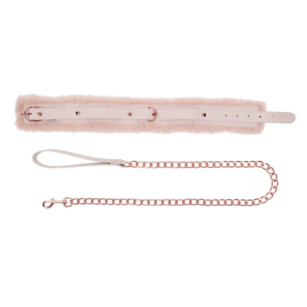 Peach fur collar laid out flat with the buckle strap and chain leash below