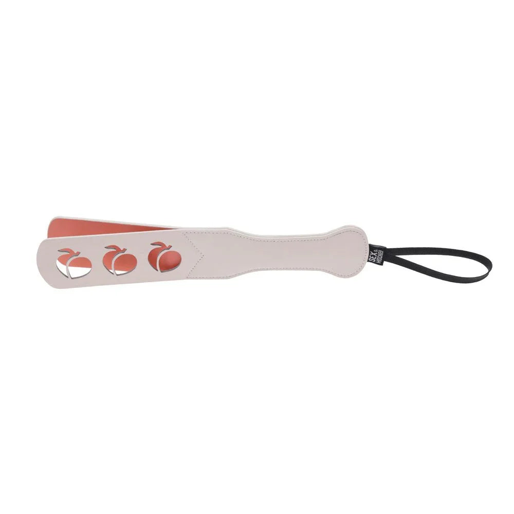 Peach impression paddle angled, coral underside showing through the cut-outs