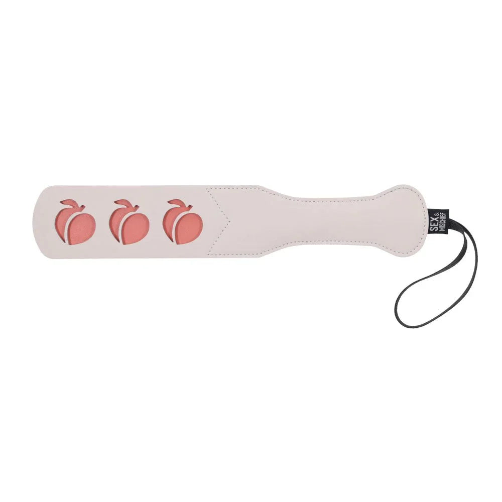 Peach impression paddle laid horizontally, three peach shapes on the blade