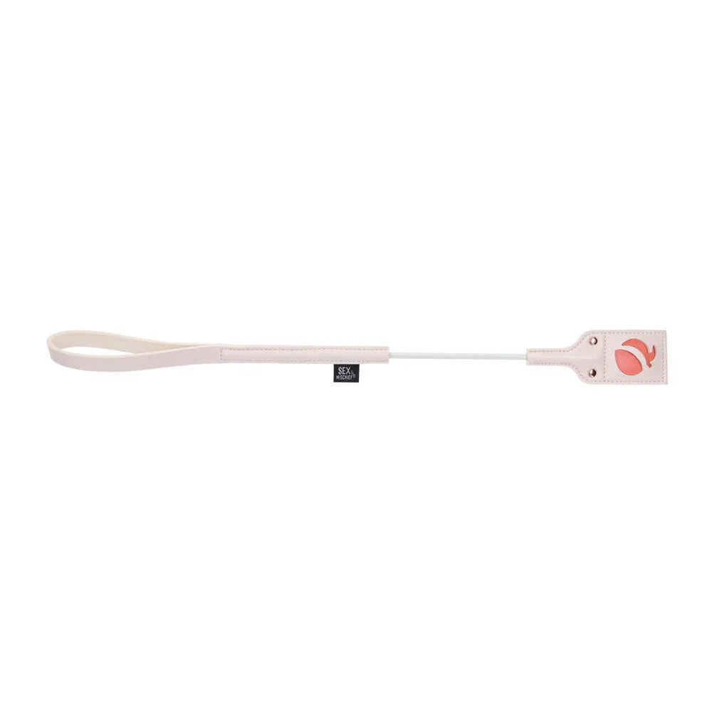Peach Impressions Crop laid horizontally, motif tip at right and wrist loop at left